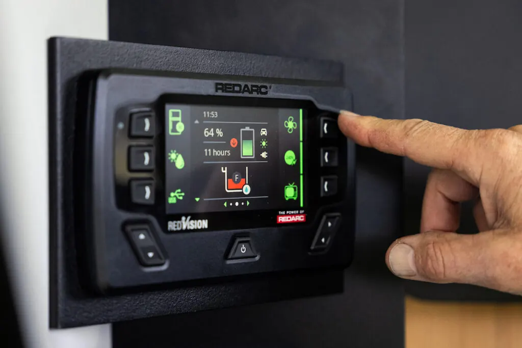 A finger pressing a power control panel inside a Stockman build