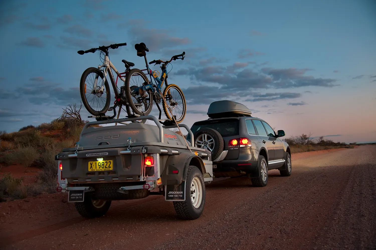 All Roada Pod Trailer with bikes loaded, behind a VW on an outback road at dusk