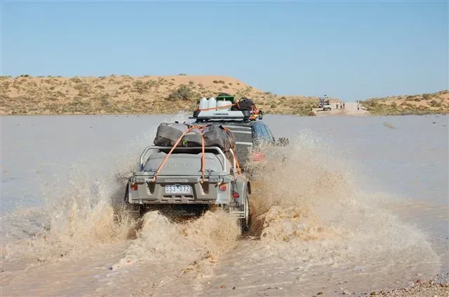 Pod Trailer towed through a water crossing on the track to Big Red