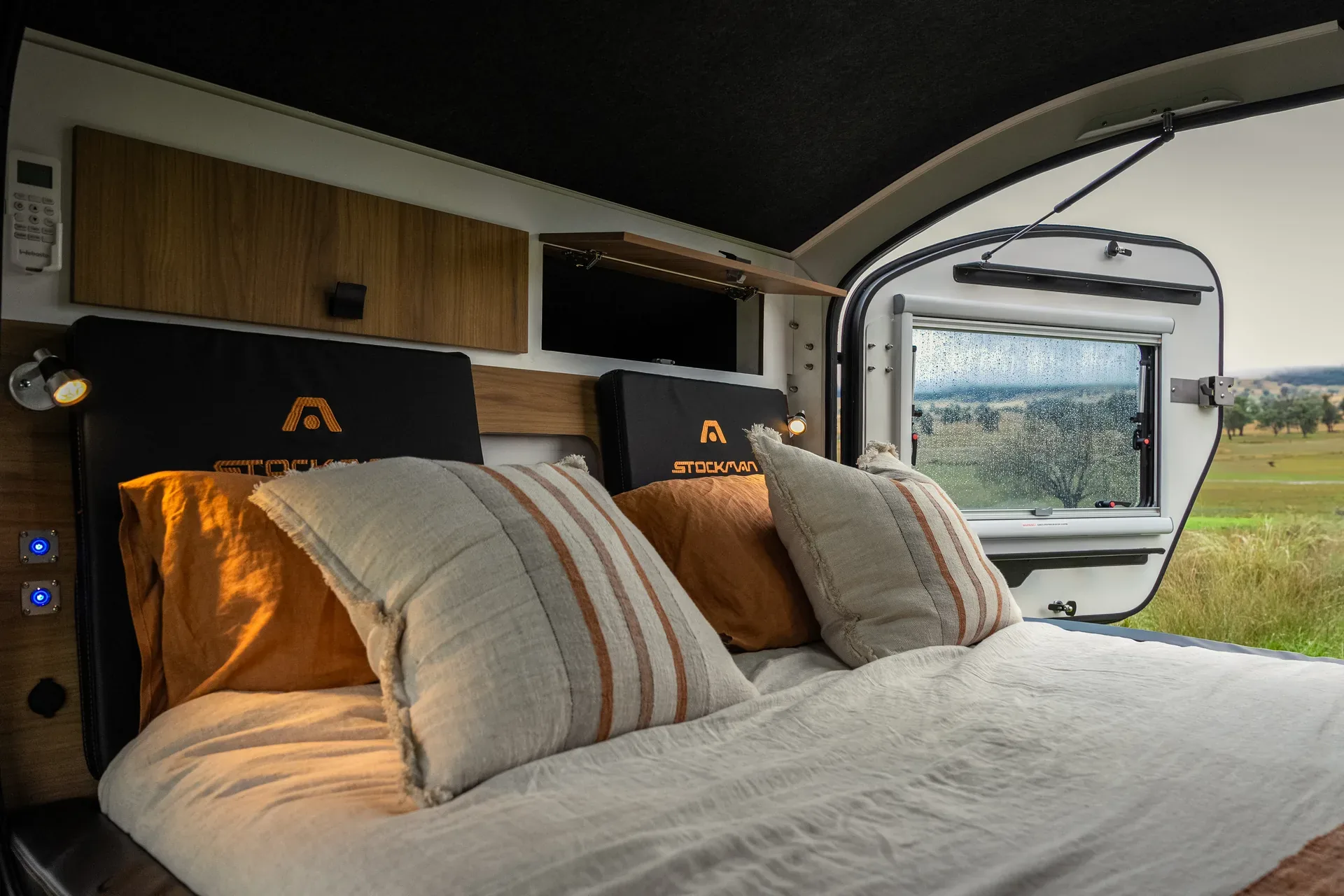 Rover cabin interior with window, bed and overhead storage