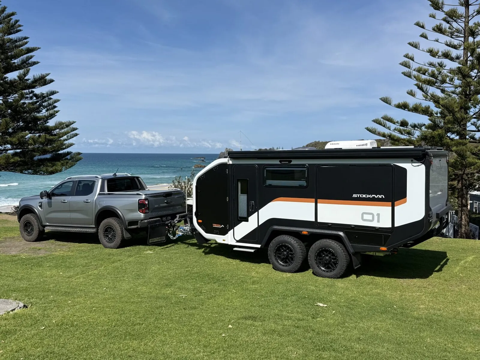 A Stockman Trekka hitched to a ute beside the coast