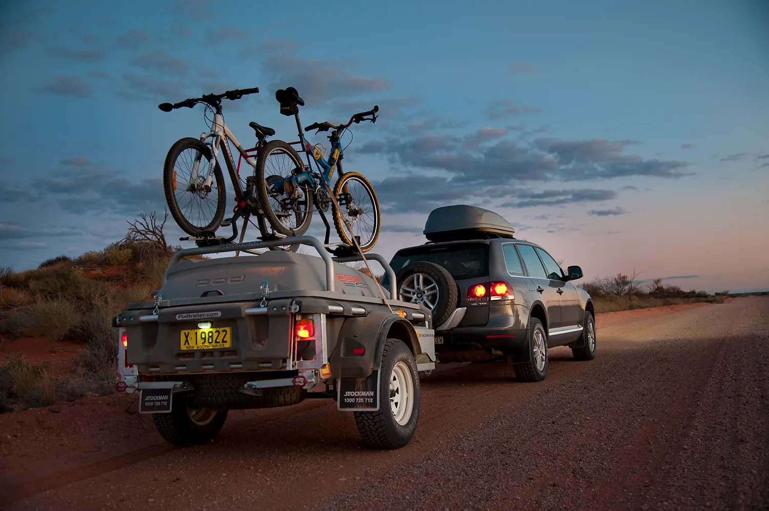 All Roada Pod Trailer with bikes loaded, behind a VW on an outback road at dusk