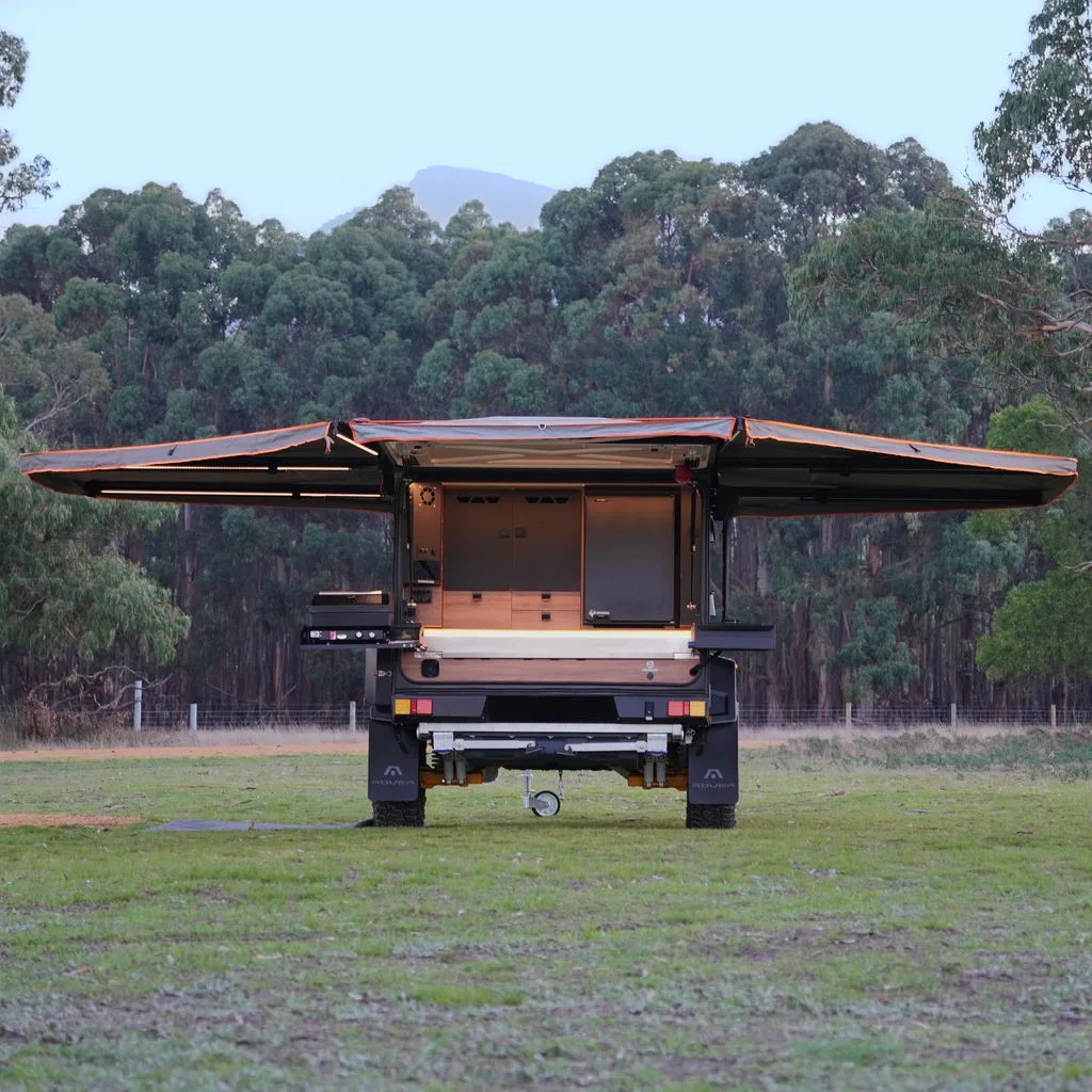 Rover set up at camp with the Darche swing awning open over the kitchen