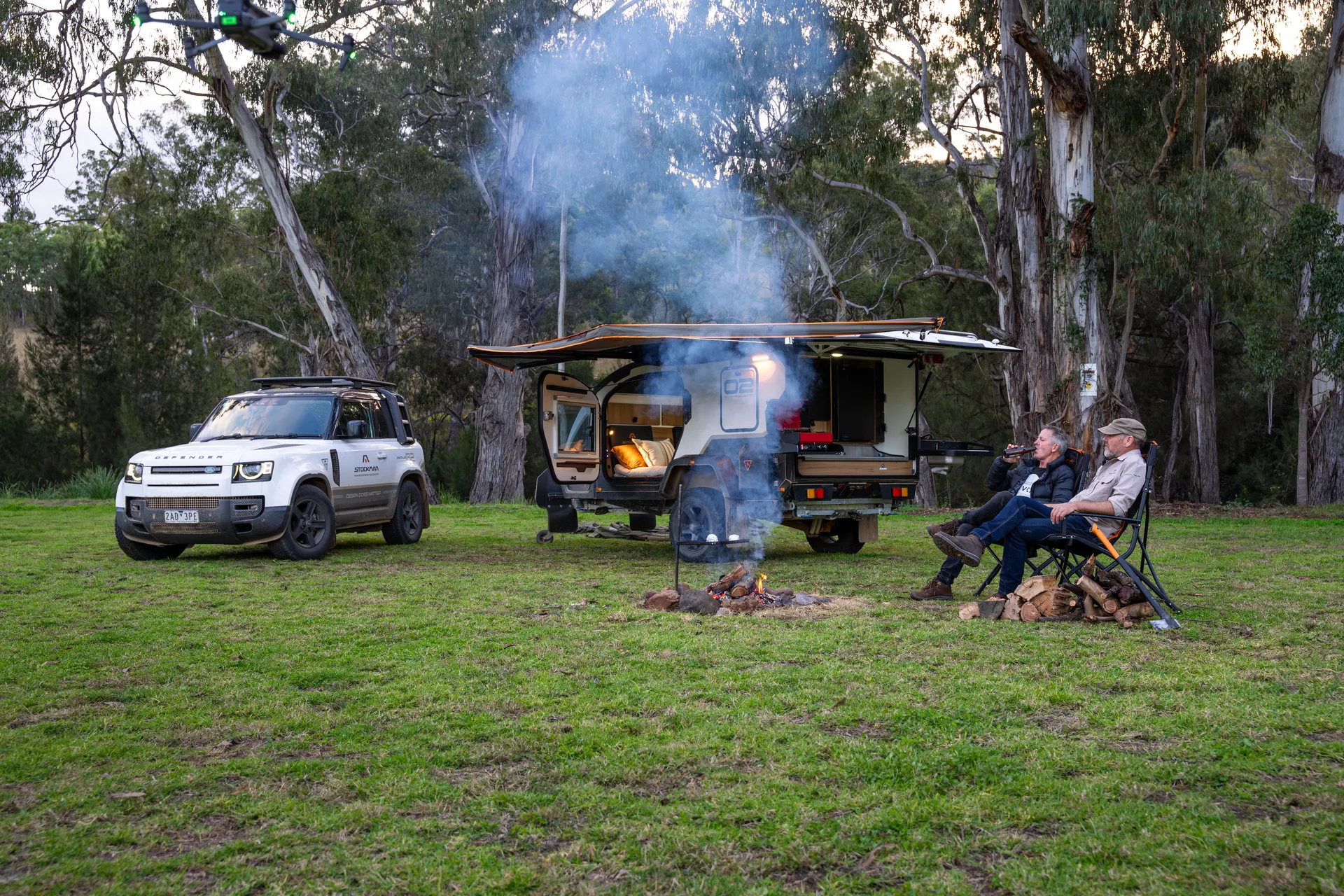Two Stockman owners relaxing by the campfire beside their Rover